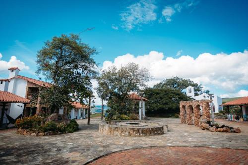 a courtyard with a fountain in front of a building at El Pueblito Hotel Boutique in Samaipata