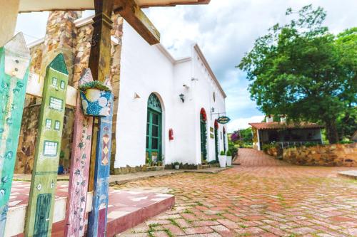 a white church with a cobblestone street at El Pueblito Hotel Boutique in Samaipata