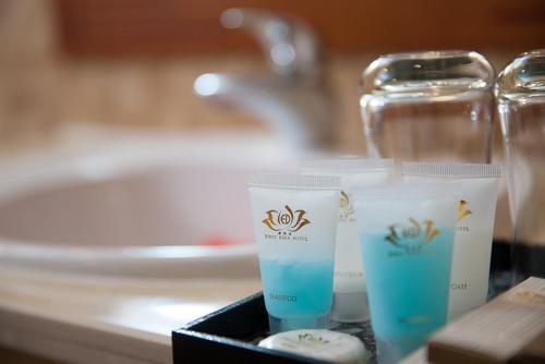 a close up of two cups sitting on a counter at First Eden Hotel - Hang Bun in Hanoi