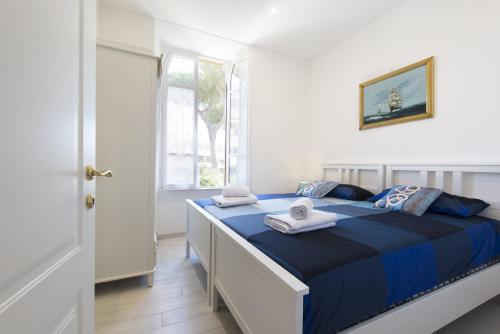 a bedroom with a bed with towels on it at Villino Emanuele in Santa Marinella