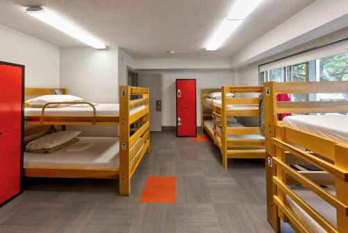 a dorm room with four bunk beds in it at HI Edmonton - Hostel in Edmonton