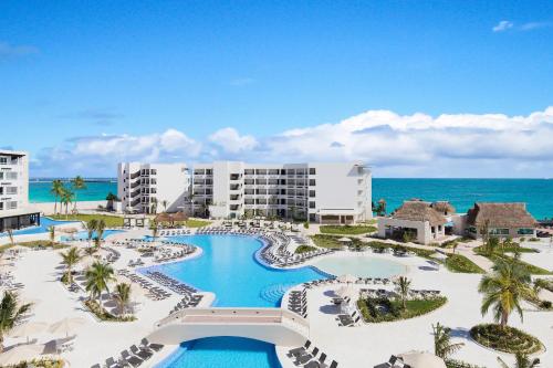 an aerial view of a resort with a pool and the ocean at Ventus at Marina El Cid Spa & Beach Resort - All Inclusive in Puerto Morelos