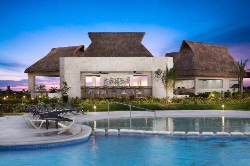 a villa with a swimming pool and a resort at Ventus at Marina El Cid Spa & Beach Resort - All Inclusive in Puerto Morelos