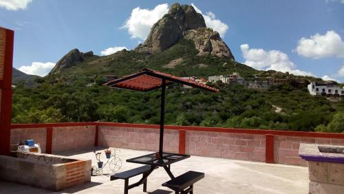 a picnic table with a mountain in the background at Hotel Mirador Real in Bernal