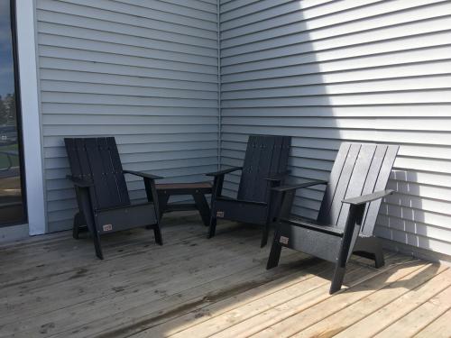 two chairs and a table on a porch at Superior Inn in Superior