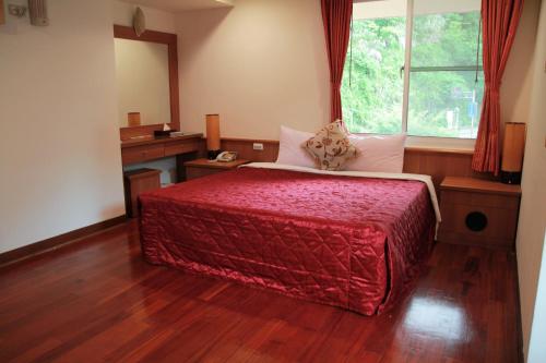 a bedroom with a large bed and a window at Li Tang in Baihe