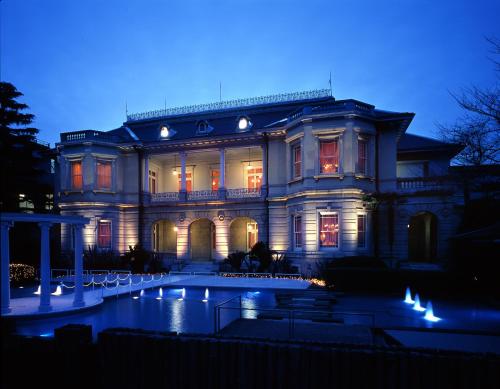 a large house with a pond in front of it at Grand Prince Hotel Takanawa in Tokyo