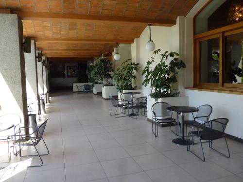 a corridor with tables and chairs in a building at Hotel Fortin Plaza in Oaxaca City