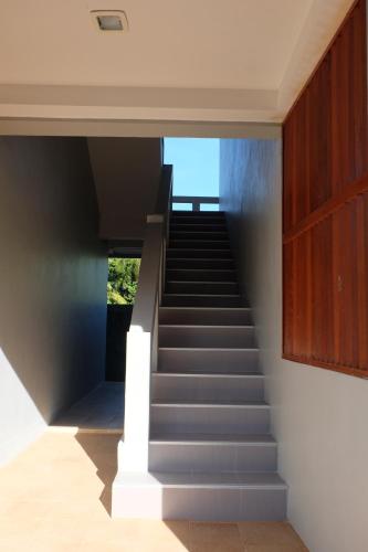a staircase in a house with grey steps at Billabong Hotel and Cafe in Baan Tai