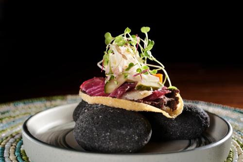 a sandwich on top of rocks on a plate at Six Senses Uluwatu in Uluwatu