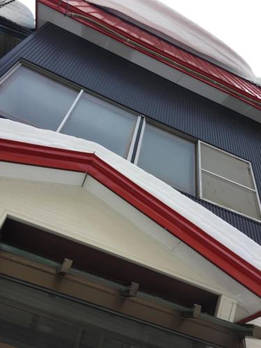 an open window on the side of a house at Cool-Residence OTARU in Otaru
