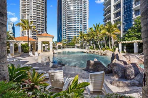 a swimming pool in the middle of a city with tall buildings at Holiday Holiday Chevron Renaissance Apartments in Gold Coast