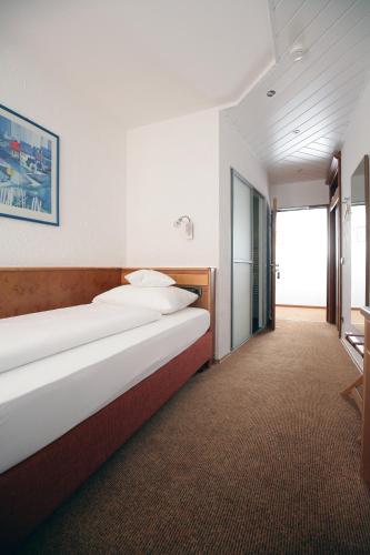 a bedroom with a large bed in a room at Badhotel Restaurant Stauferland in Bad Boll