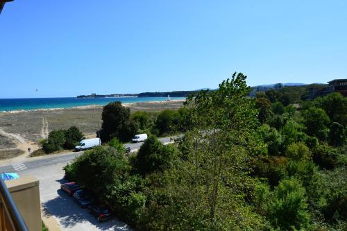 a view of a beach with cars parked in a parking lot at Aparthotel Hotel Prestige City II in Primorsko