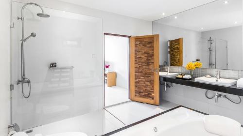 a bathroom with two sinks and a shower with a glass door at Beach Republic Koh Samui in Lamai