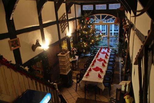 a dining room with a table and a christmas tree at Hotel Café am Stift in Hessisch Oldendorf