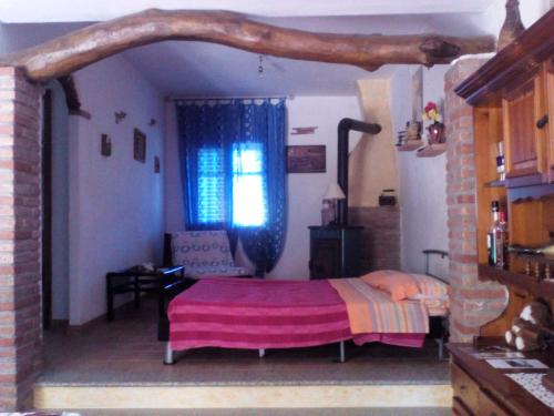 a bedroom with a bed with a tree branch above it at Appartamento MareMontagna in Cardedu