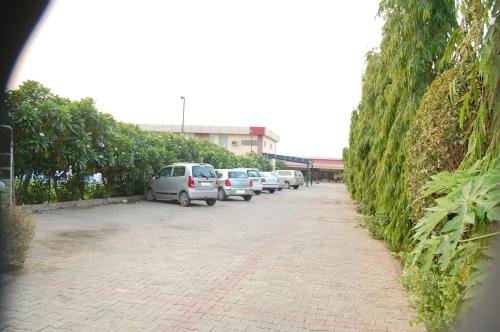 a row of cars parked in a parking lot at JPS Residency & Hospitality Services in Gurgaon