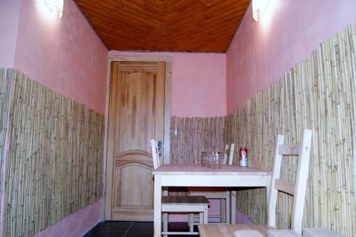 a dining room with a table and two chairs at Rakhiv Plai in Rakhiv