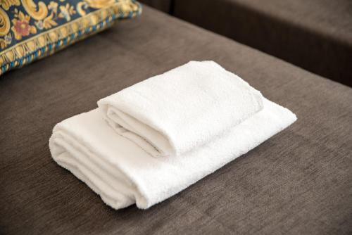 a pile of white towels sitting on a table at Ca' Dorina Luxury in Venice
