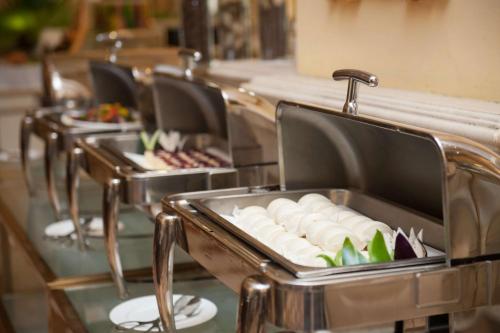 a row of plates of food on a table at Guangzhou Phoenix City Hotel-Free Shuttle for Canton Fair 15th Oct to 5th Nov in Zengcheng