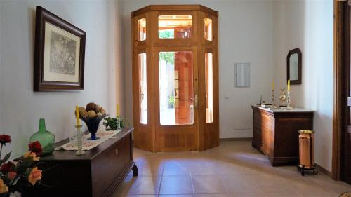 a living room with a wooden door and a table at Born 23 - House with Pool in the centre of Lluchmayor. free wifi in Llucmajor