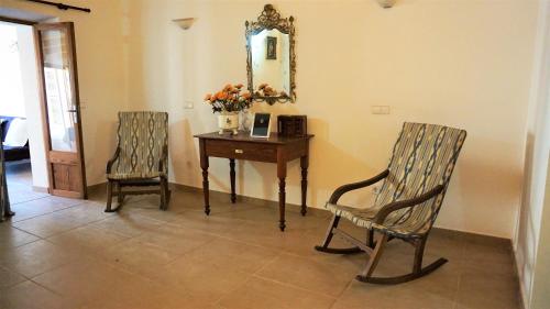 a room with a table and two chairs and a mirror at Born 23 - House with Pool in the centre of Lluchmayor. free wifi in Llucmajor