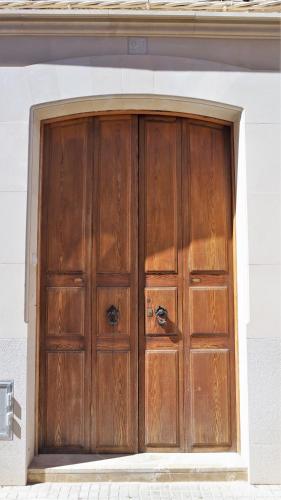 a pair of wooden doors on a building at Born 23 - House with Pool in the centre of Lluchmayor. free wifi in Llucmajor