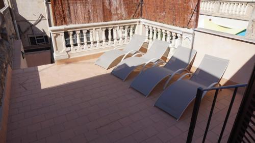 a group of chairs sitting on a balcony at Born 23 - House with Pool in the centre of Lluchmayor. free wifi in Llucmajor