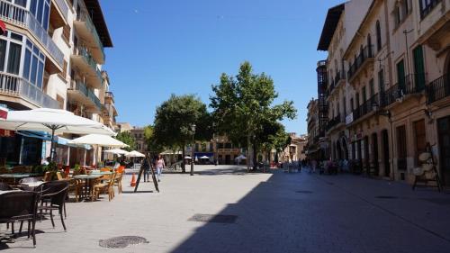 an empty street with tables and chairs and buildings at Born 23 - House with Pool in the centre of Lluchmayor. free wifi in Llucmajor