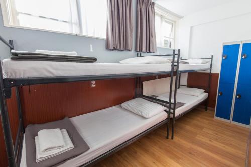 a room with two bunk beds and a window at Travel Hotel Amsterdam in Amsterdam