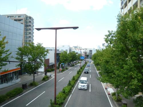 a street with cars driving down a city street at Nagoya Motoyama House D in Nagoya