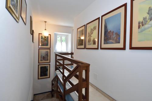 a hallway with a staircase with pictures on the wall at Bellagio Bed & Breakfast in Bellagio
