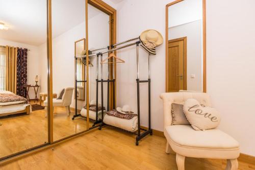 a dressing room with a mirror and a chair at Cabanas2stay in Cabanas de Tavira