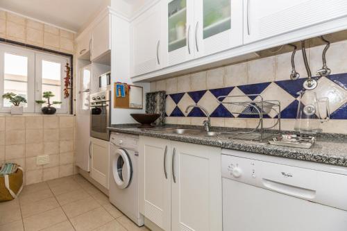 a kitchen with a sink and a dishwasher at Cabanas2stay in Cabanas de Tavira