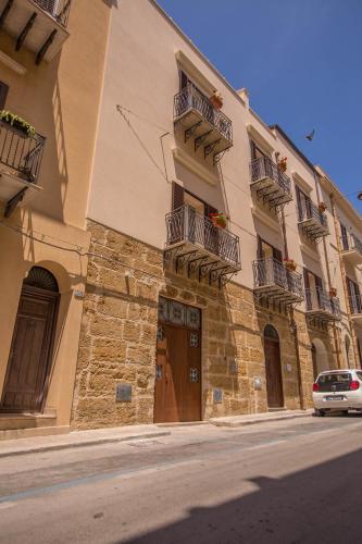 a building with balconies and a car parked in front of it at Sciabika Home - Edificio Eolie in Castellammare del Golfo