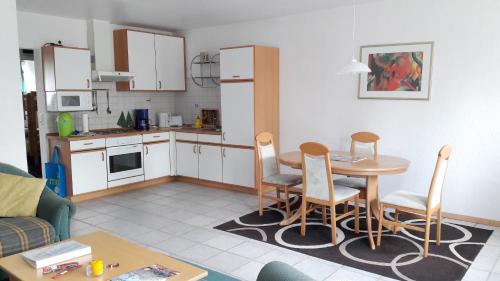 - une cuisine avec une table et des chaises dans le salon dans l'établissement Ferien- und Reiterparadies Voßhörnerhof, à Neuschoo