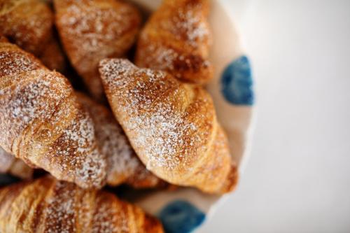 a pile of sugar dusted pastries on a plate at Hotel Torre Barbara in Vico Equense
