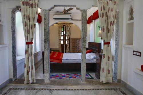 A bed or beds in a room at Barabagh Deogarh - A Heritage Farm Stay