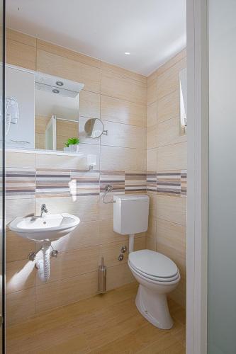a bathroom with a toilet and a sink at Apartmani Mihailovic in Budva