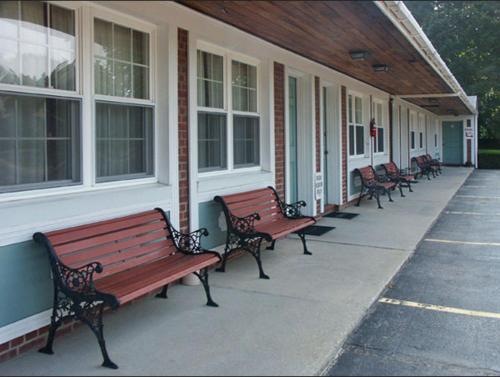 a row of benches sitting outside of a building at Catamount Motel in Bennington