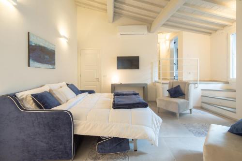 a bedroom with a large bed and a chair at Carapelli Apartments in Florence