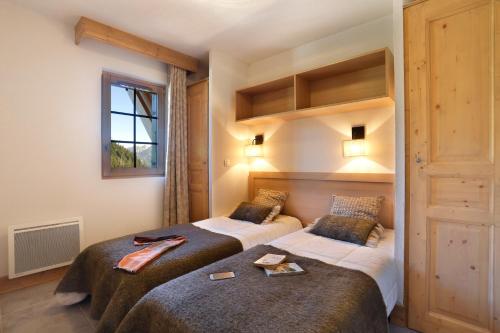 En eller flere senge i et værelse på Résidence Goélia Le Grand Ermitage