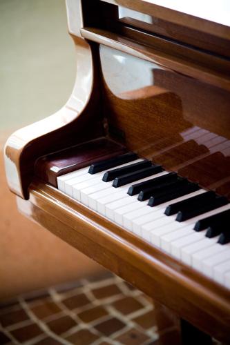 a close up of a wooden piano at Hotel Savoia in Alassio