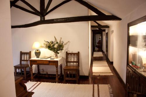 a hallway with a table and chairs in a room at Quinta da Cumieira in Cumieira