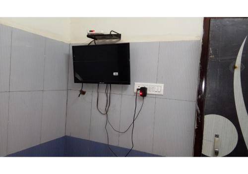 a room with a tv on a wall at Hori Om Palace in Bharbharia