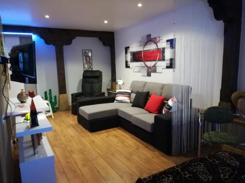 a living room with a couch and a tv at Posada Ormas in Ormas