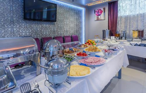 
a buffet table with many plates of food at Victoria Plaza in Pereslavl-Zalesskiy
