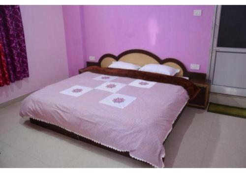 a bedroom with a bed with a purple wall at Mountain Facing Rooms in Shimla in Shimla