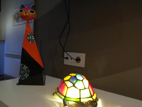 a lamp sitting on a table next to a neck tie at Posada Ormas in Ormas